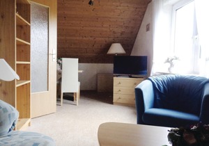 The apartment is located in a three-family house.