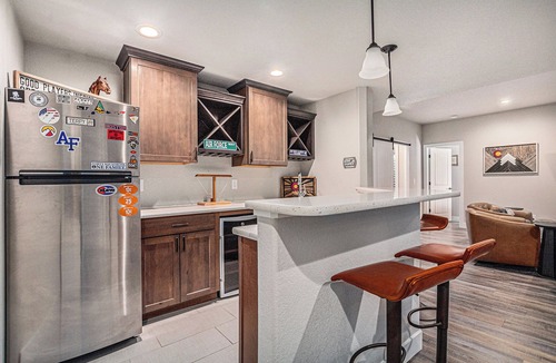 Gleneagle House | 5 Bedroom house with amenities galore! Oversized hot tub, outdoor fire pit, smoker and propane grill, sauna, play set, espresso machine, air hockey table, indoor fireplace in both living rooms, and legacy bar.