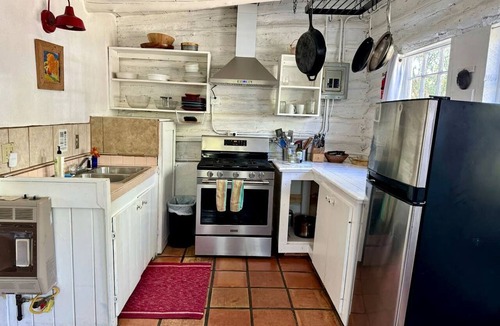 San Cristobal Cabin | Log Casita Overlooking Pond and Waterfall near Taos, New Mexico