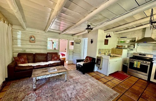 San Cristobal Cabin | Log Casita Overlooking Pond and Waterfall near Taos, New Mexico