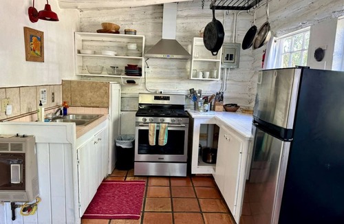 San Cristobal Cabin | Log Casita Overlooking Pond and Waterfall near Taos, New Mexico
