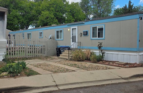 Longmont House | Relaxing home with landscaped back yard . Table and chairs outdoors.