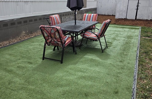 Longmont House | Relaxing home with landscaped back yard . Table and chairs outdoors.
