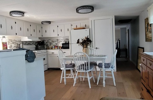 Longmont House | Spacious mobile home with large kitchen/living area and porch with barbeque.