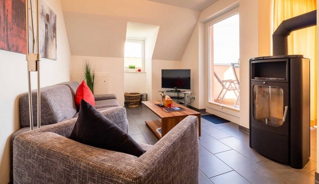 Exclusive vacation apartment Seedüne 13 in Großenbrode. Stylish bedroom with access to the roof terrace with fabulous sea views. Exclusive wellness oasis. Own house bar for special moments of pleasure