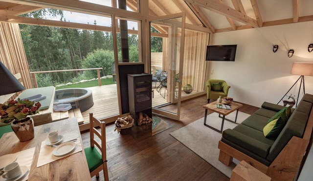 Premium forest chalet with panoramic forest views and a heated hot tub on the terrace