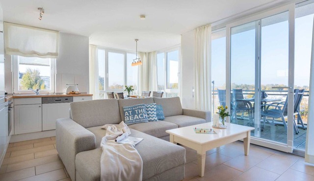 Vacation apartment Strandperle 9 in Großenbrode. Wonderful balcony to relax on. Exclusive wellness oasis with sauna & corner bathtub. Seasonal beach chair included. Practical washing machine available